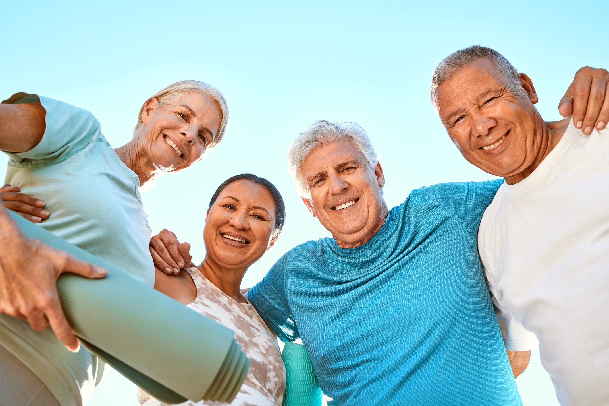 group of older adults with yoga mat