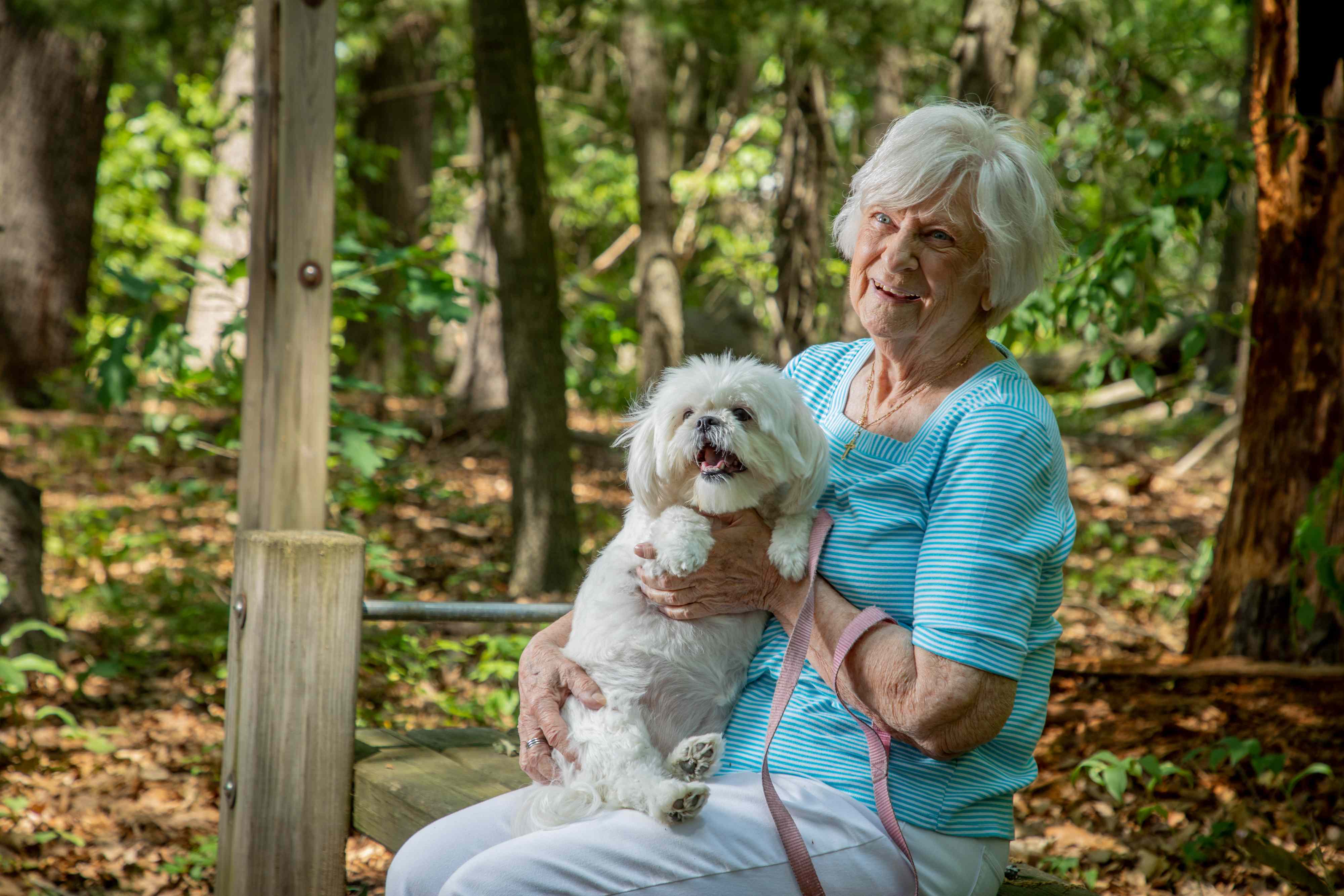 female senior with white dog
