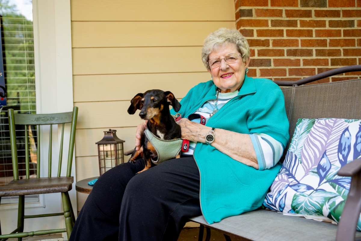 female on patio with dog