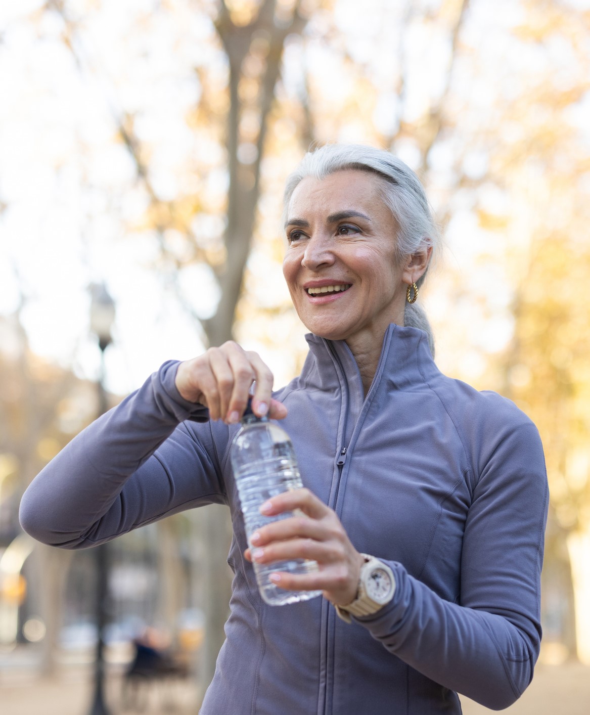 woman with water bottle in a fall setting