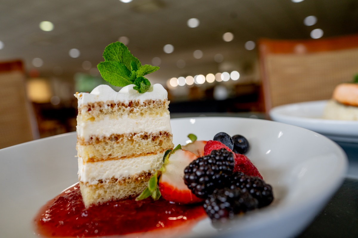 cake with strawberry sauce and fruit